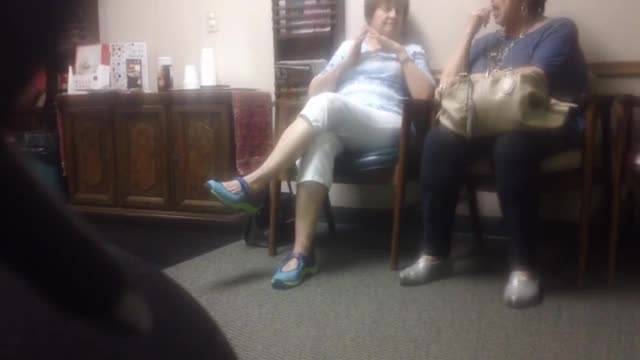 Two mature women working their toes in their shoes